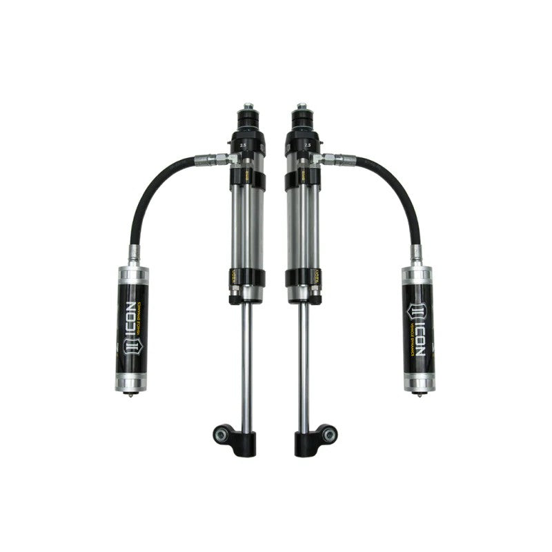 A pair of ICON RXT Omega Series 2.5 remote reservoir rear bypass shocks with black aluminum components for Toyota Tacoma.