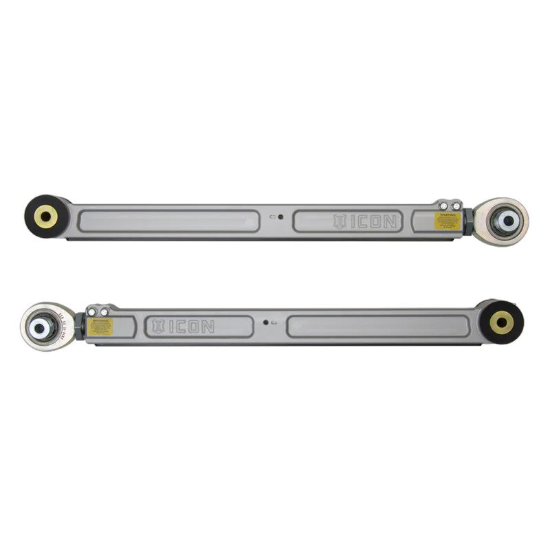 CNC-machined 6061 billet aluminum lower trailing arms with PTFE-lined rod ends and black nylon rock sliders.