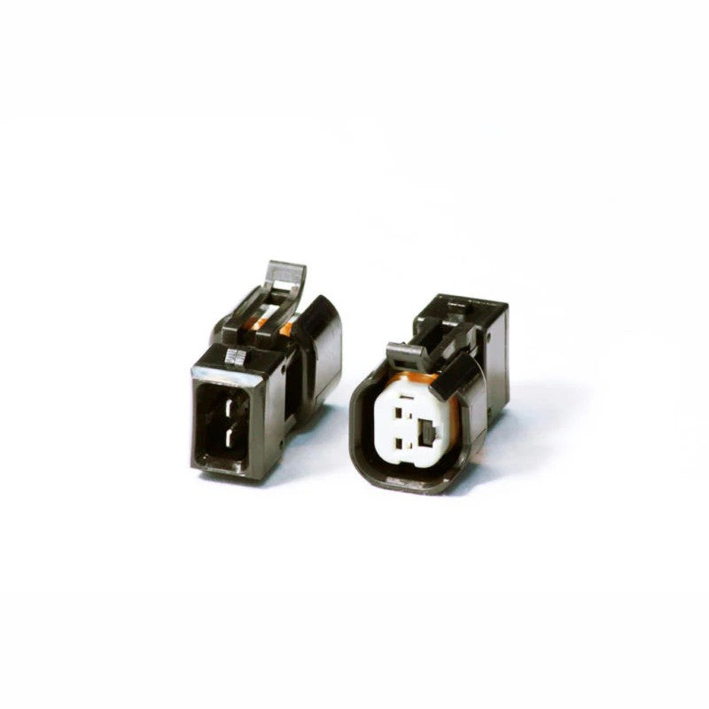 Injector Dynamics USCAR to EV1 plug-and-play fuel injector wiring adapter with black plastic molded connectors.