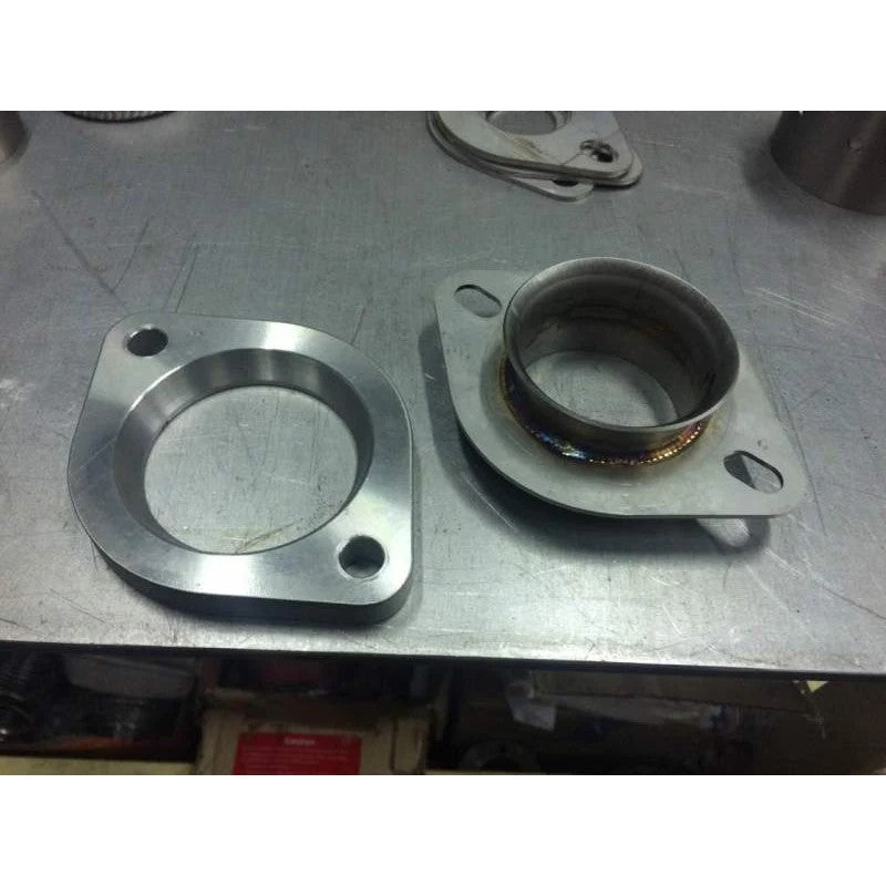Invidia stainless steel adapter for Subaru stock downpipe to 3-inch catback exhaust flange.