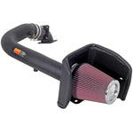 K&N 57-2556 performance air intake system with black HDPE tube, red oiled cotton filter, and custom heat shield.