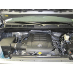 K&N 33-2387 high-flow washable air filter with red oiled cotton media and black perimeter seal.