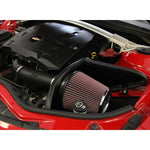 K&N AirCharger intake system with black HDPE induction tube, heat shield, and red oiled cotton conical air filter.