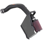 K&N 57-3025-1 air intake kit featuring a black HDPE tube, red conical air filter, and black heat shield.