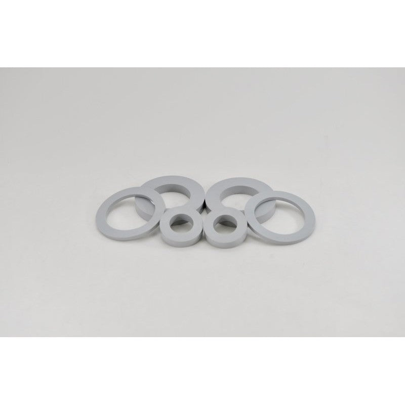 Two black polyurethane Kartboy rear differential bushings for 2002-2007 Subaru WRX and STI models
