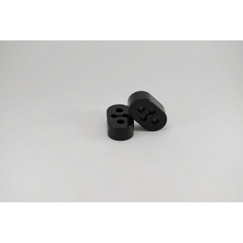 Black Kartboy 12mm high-durometer polyurethane exhaust hanger for Subaru WRX and Legacy GT.