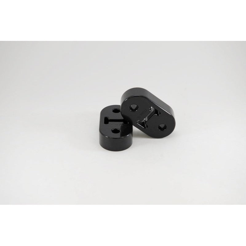 Black polyurethane Kartboy 12mm long exhaust hanger with two mounting holes for Subaru WRX and Legacy GT.