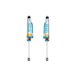 Pair of King 2.5 inch diameter front shocks with blue anodized components, hose-mounted reservoirs, and adjusters.