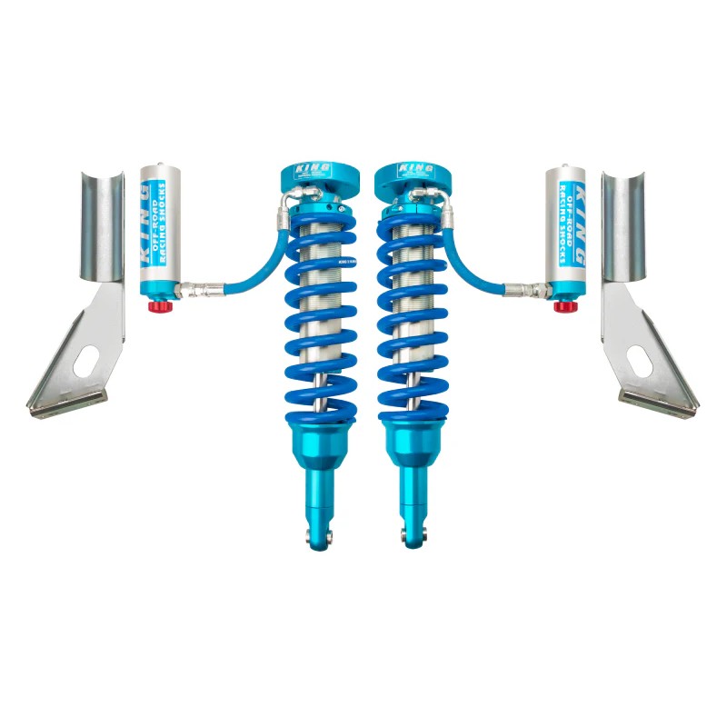Pair of King 2.5 front coilovers with remote reservoirs, blue springs, and compression adjusters.
