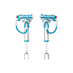 King Shocks 2.5 OEM Performance front shocks with blue remote reservoirs and compression adjustment knobs.