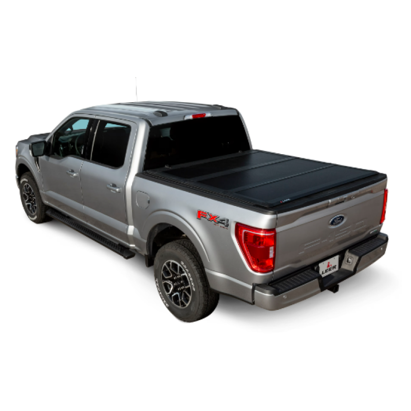 LEER HF650M low-profile hard folding tonneau cover with CYNC latching system on a 2015-2023 Ford F-150 5'6" bed.