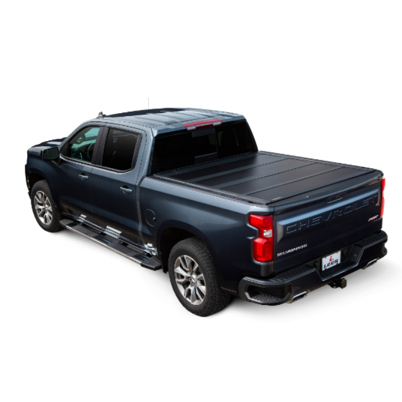 LEER HF650M black low-profile four-panel hard folding tonneau cover mounted on a Chevrolet Silverado truck bed.