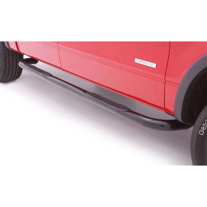 Lund 3-inch black round bent steel nerf bars with curved ends and recessed non-slip rubber step pads.