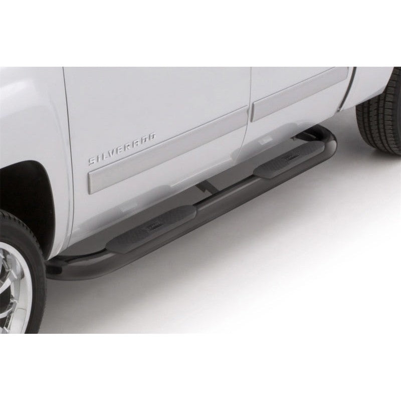 Lund 4 inch oval curved black steel nerf bars with non-slip rubber step pads for Chevrolet Silverado and GMC Sierra.