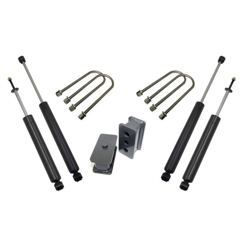 MaxTrac 2.5-inch rear lift kit components including cast lift blocks, mounting U-bolts, and twin-tube shocks