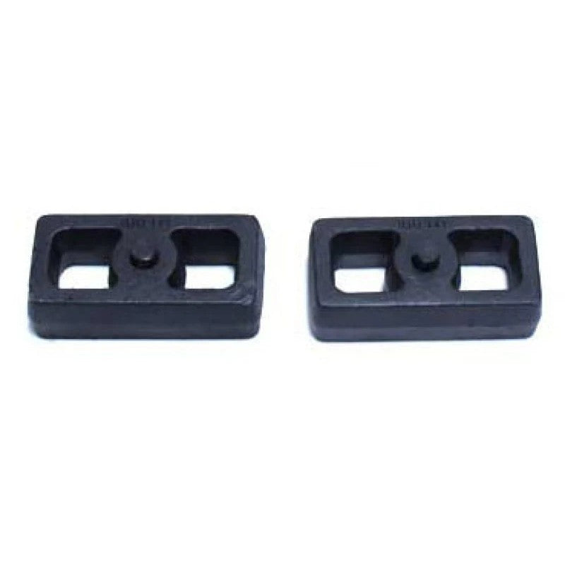 Pair of MaxTrac 1.5-inch black cast steel rear lift blocks for truck suspension.