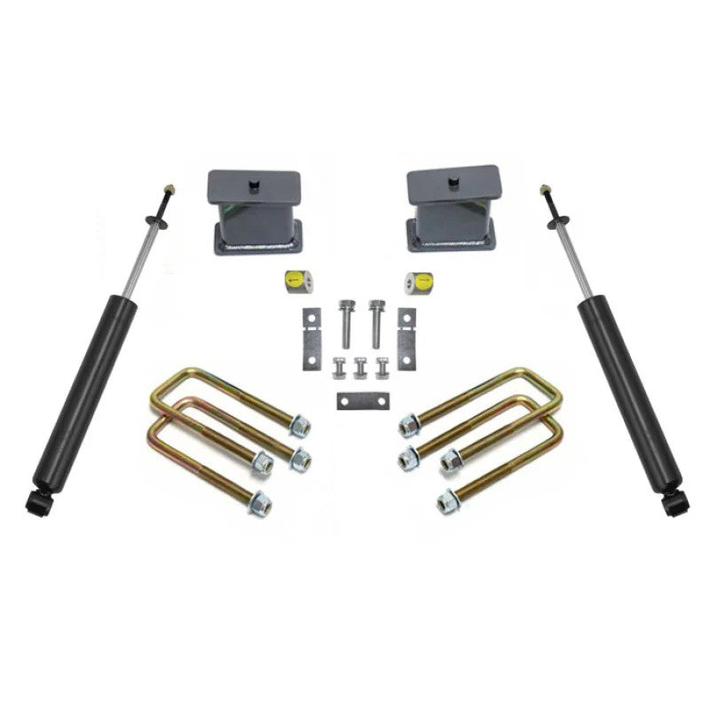 MaxTrac 4-inch rear lift kit including lift blocks, strut spacers, U-bolts, brackets, and a pair of rear shocks.