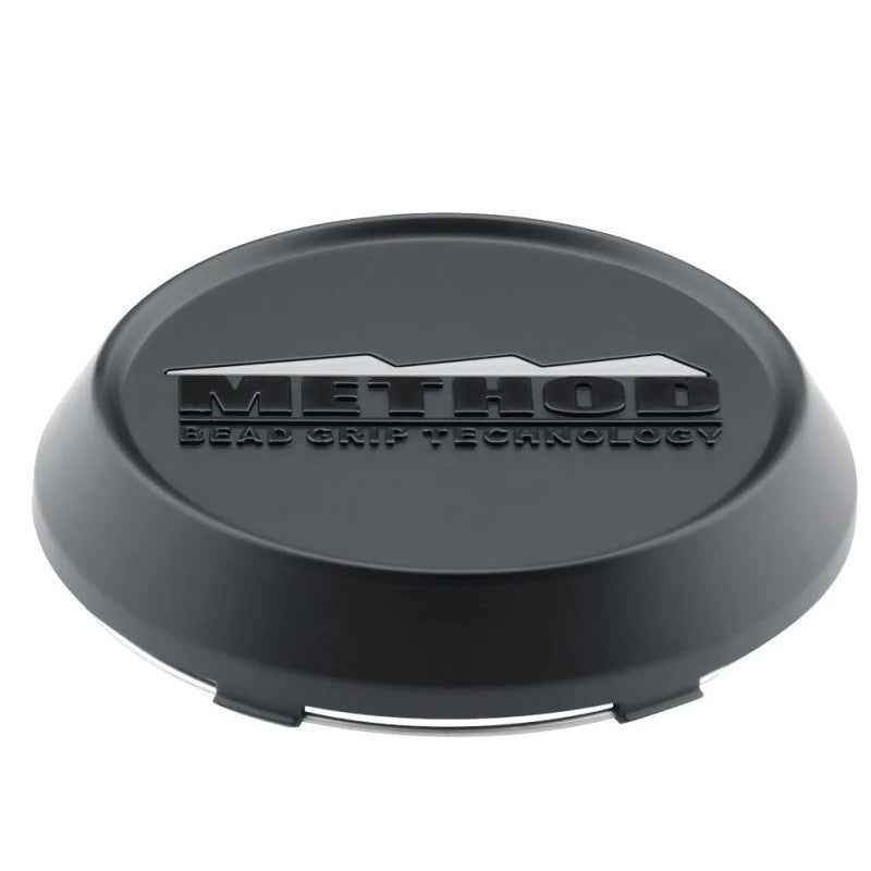 Method Race Wheels T080 104mm snap-in center cap in a matte black finish with embossed logo.