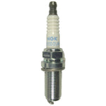 Four NGK Iridium Racing spark plugs with white ceramic insulators and silver trivalent metal shells.
