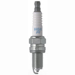 Set of four NGK Standard DCPR6E spark plugs with nickel alloy electrodes and white corrugated ceramic insulators.