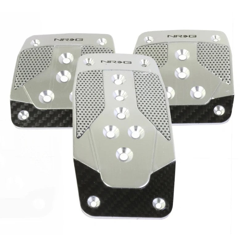NRG silver aluminum manual transmission sport pedals with black carbon fiber inserts.