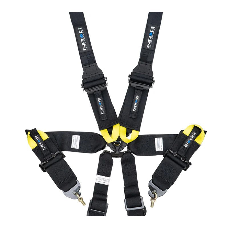 Black NRG FIA 6-point racing harness featuring 2-inch shoulder straps for HANS devices and a rotary cam lock buckle.