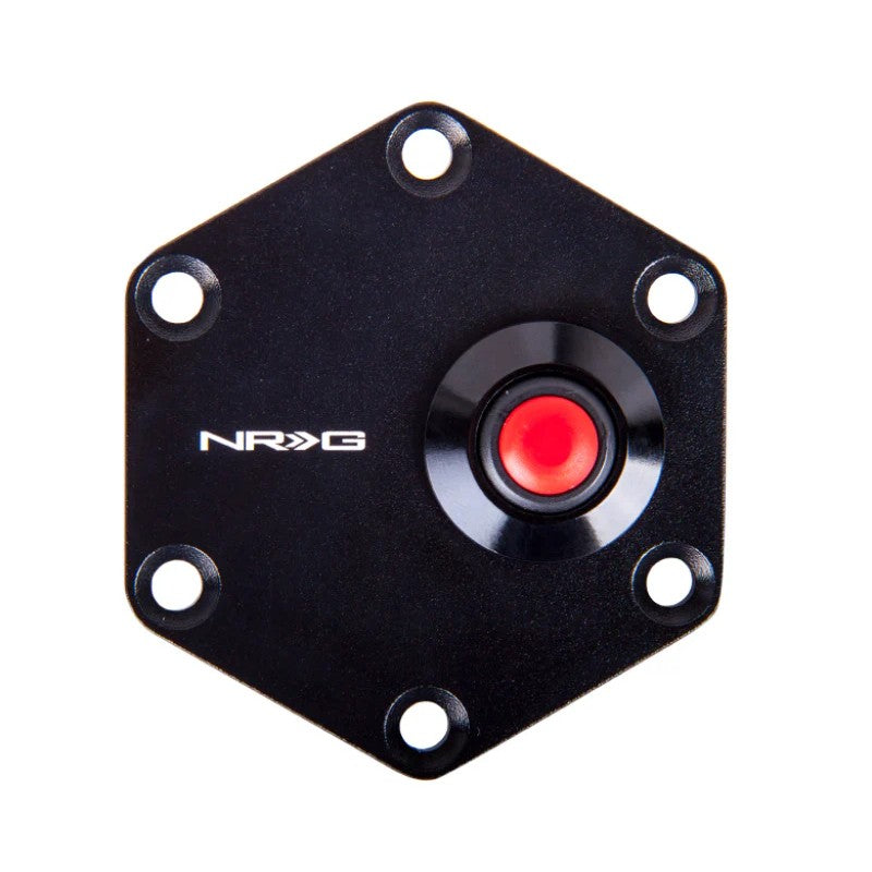 Black hexagonal steering wheel trim ring with an integrated centered circular horn button.