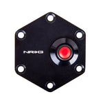 Black hexagonal steering wheel trim ring with an integrated centered circular horn button.
