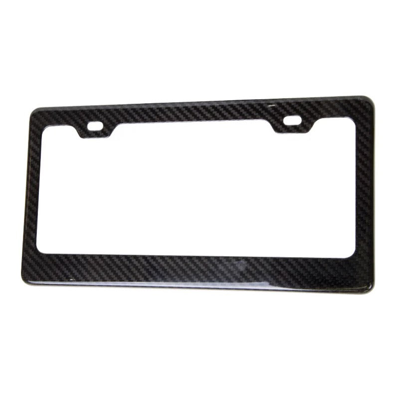 Genuine NRG carbon fiber license plate frame featuring a glossy weave finish and standard four-hole mounting design.