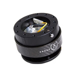NRG Gen 2.0 steering wheel quick release featuring a black anodized body and a black carbon fiber accent ring.