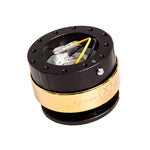 NRG Innovations Gen 2.0 steering wheel quick release with a black aluminum body and a chrome gold textured ring.