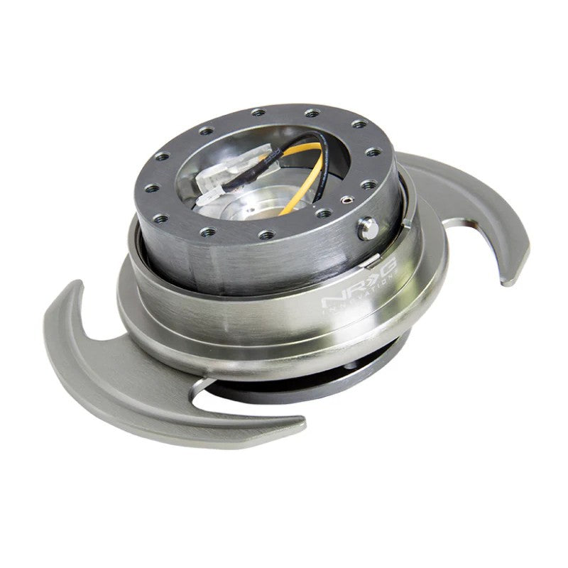 NRG Gen 3.0 steering wheel quick release in gunmetal finish featuring flared handles and ball-lock mechanism.