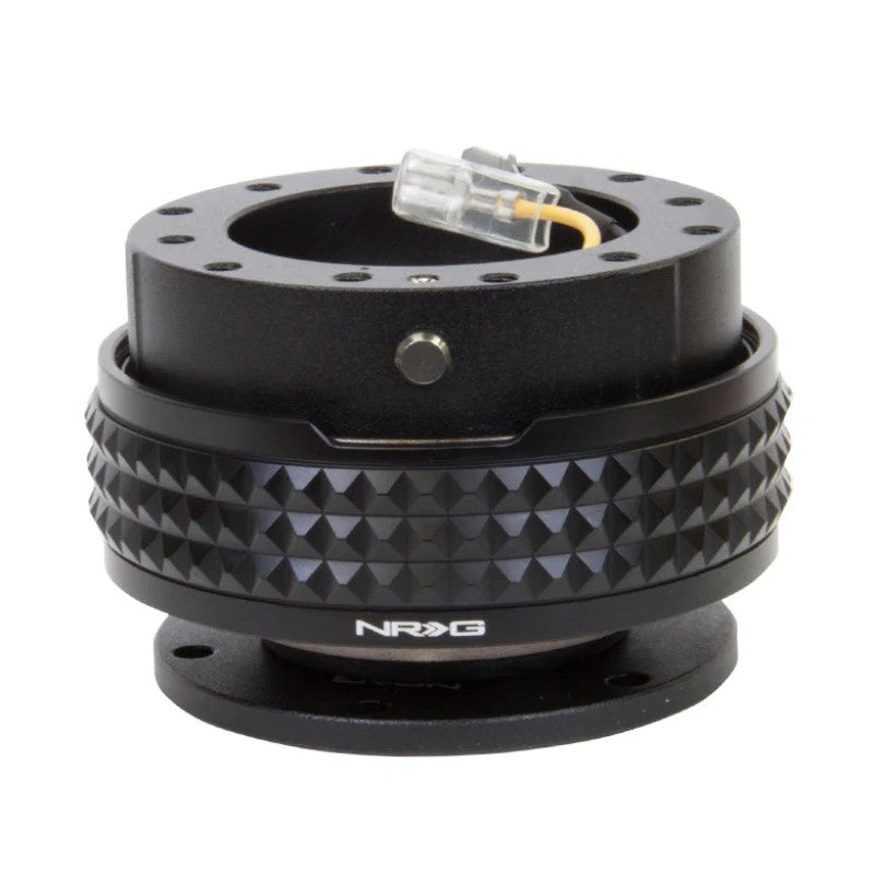 Black NRG Innovations Pyramid Edition steering wheel quick release kit featuring a textured grip ring.