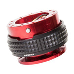 Red anodized NRG steering wheel quick release with a black pyramid-textured grip ring and internal ball-lock mechanism