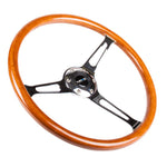 NRG 360mm reinforced steering wheel featuring a classic wood grain rim and a polished chrome 3-spoke center with cutouts.