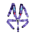 Purple NRG 5-point racing harness with 3-inch wide straps, SFI 16.1 safety tags, and a central cam lock buckle.