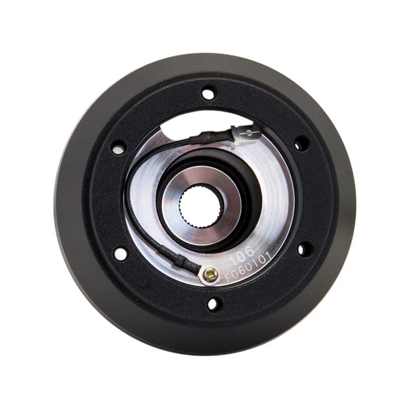 Matte black NRG Innovations SRK-106H short hub adapter showing the dual 6-bolt mounting pattern for Subaru applications.