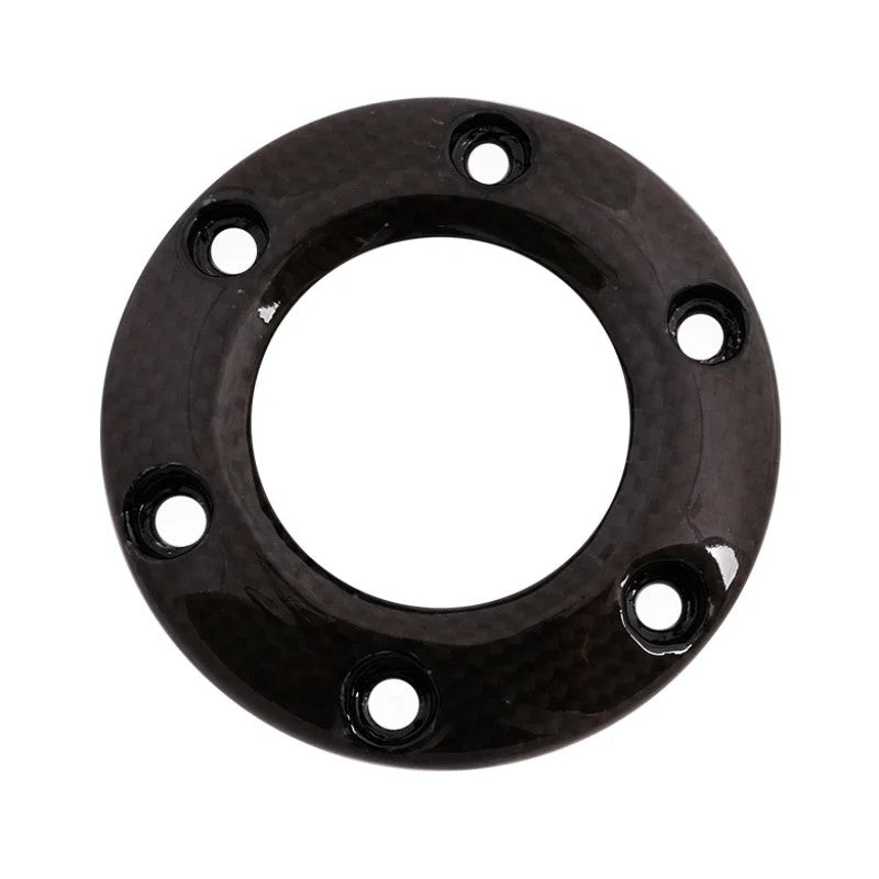Circular carbon fiber steering wheel horn button ring with high-gloss finish and six mounting holes.