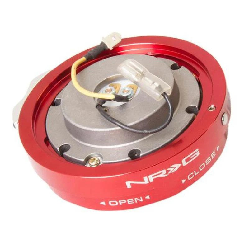 Red anodized NRG SRK-400R Thin Series steering wheel quick release showing the 6-bolt mounting flange and ball-lock system.
