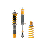Ohlins Road & Track coilover suspension kit featuring gold anodized aluminum dampers and blue coil springs.