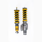 Öhlins Road & Track coilover kit with gold aluminum bodies, silver inverted struts, and black coil springs.