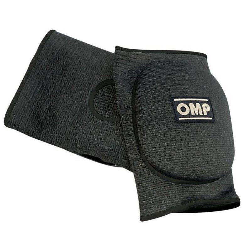 Pair of black OMP padded racing knee pads with white logo detail