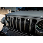 Three white 3-watt LED marker lights mounted in the factory grille openings of a Jeep Wrangler JL.