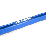 Blue anodized PERRIN aluminum battery tie down with laser-etched logo and machined finish.