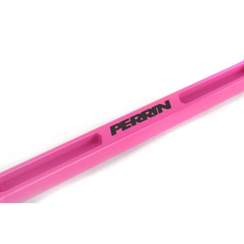 Hyper Pink anodized CNC-machined aluminum PERRIN battery tie down with etched logo.