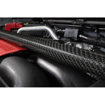 Glossy carbon fiber front strut tower bar with black mounting brackets for Subaru BRZ and Toyota GR86 engine bays.