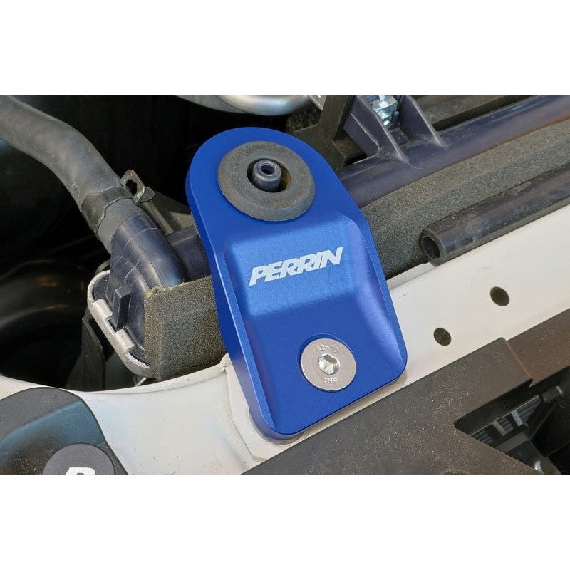 A pair of blue PERRIN upper radiator brackets for select Subaru WRX, STI, and Crosstrek models.