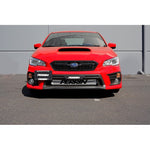 PERRIN black powder-coated aluminum license plate relocation kit mounted to a Subaru WRX front tow hook port.