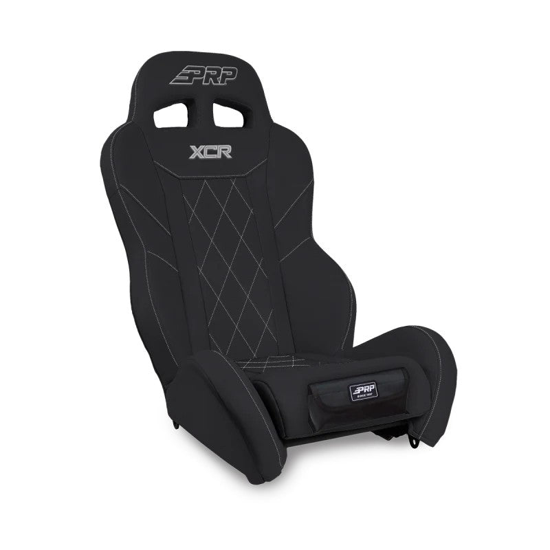 Black PRP XCR suspension seat featuring diamond stitching, dual harness slots, and a front storage pocket.