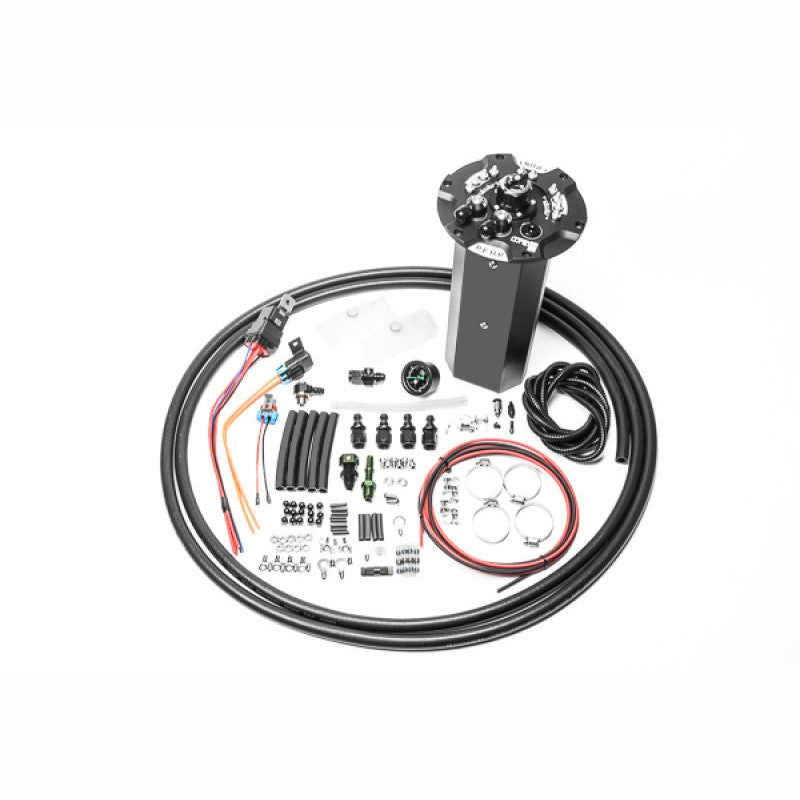 Radium CNC machined fuel hanger surge tank for Nissan 370Z featuring integrated collector box and pump mounting points.